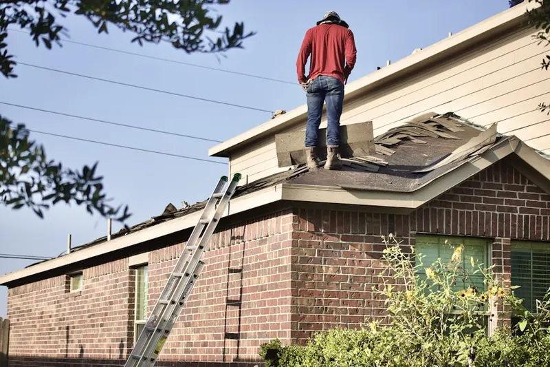 Professional roofer working on a residential roof in Redcross